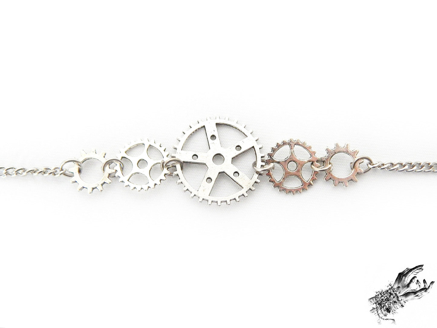 Close-up of the antique silver gear bracelet, showing the intricate silver clockwork charms, the perfect gift for Steampunk fashion in the UK
