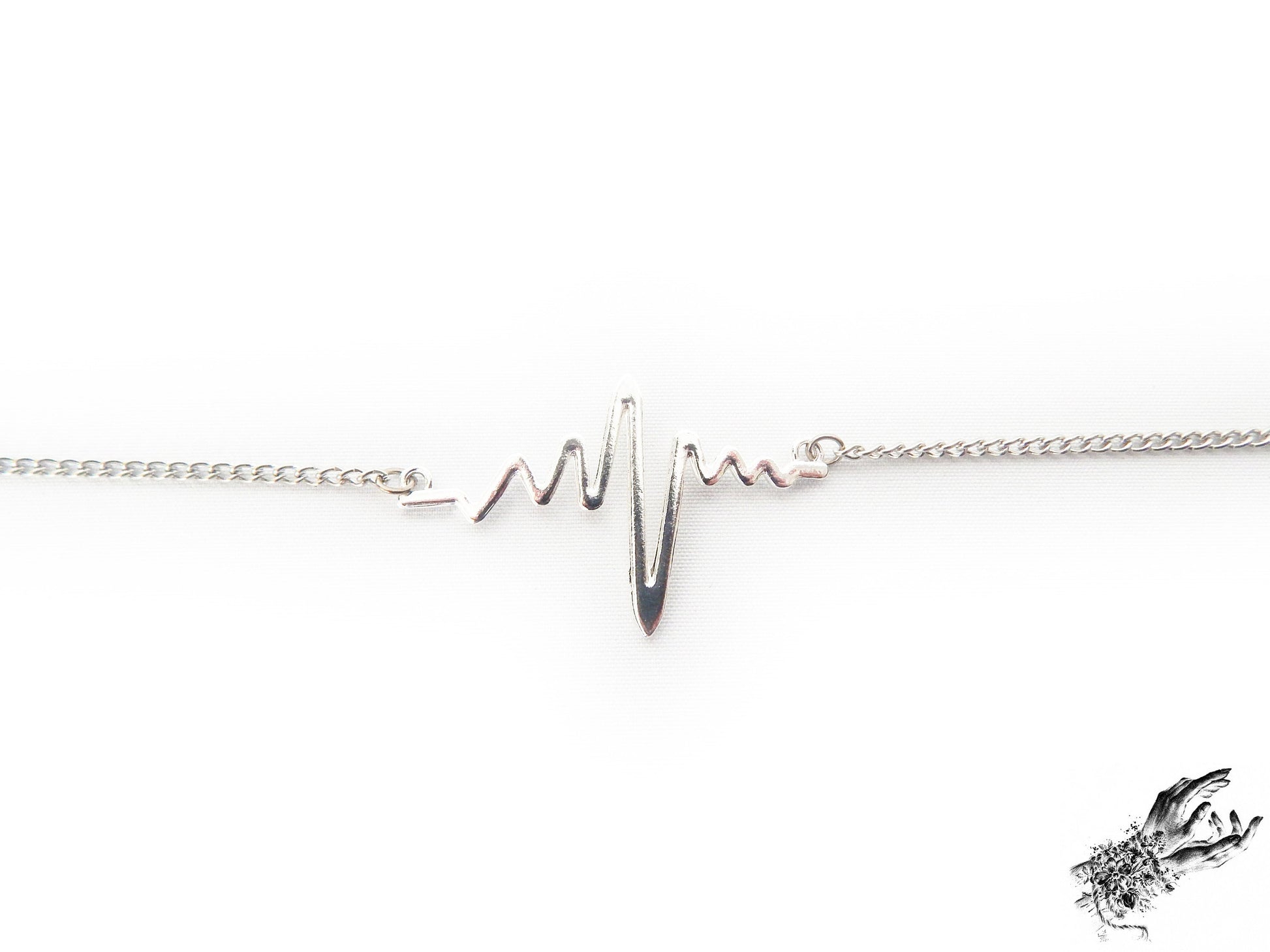 Close-up of the antique silver bracelet, showing the dainty yet striking heartbeat charm, a perfect gift for cardiologist and medical students in the UK
