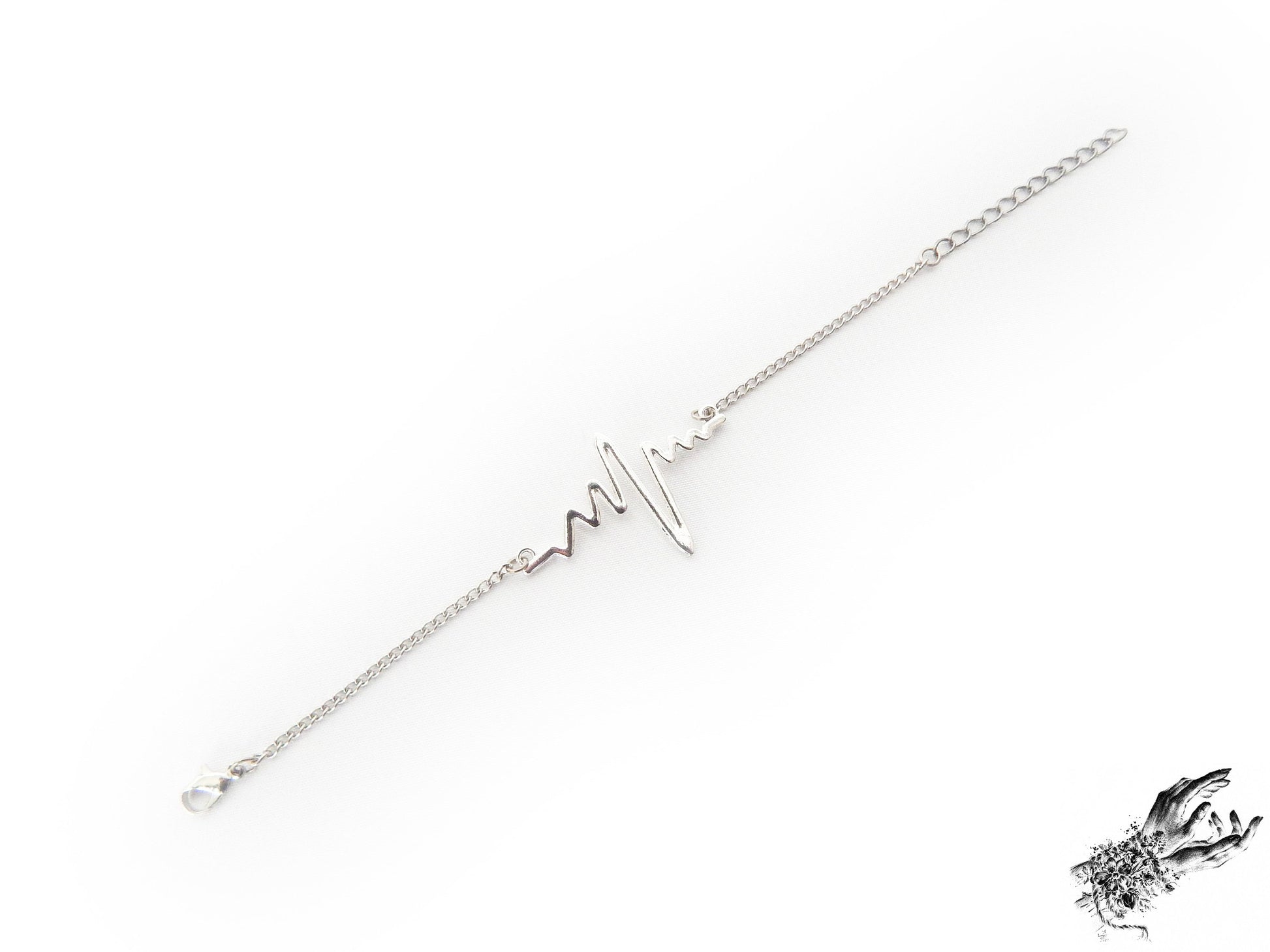 Antique silver bracelet featuring a central silver heartbeat connector charm, creating a medical inspired aesthetic perfect for cardiologist gift or medical students