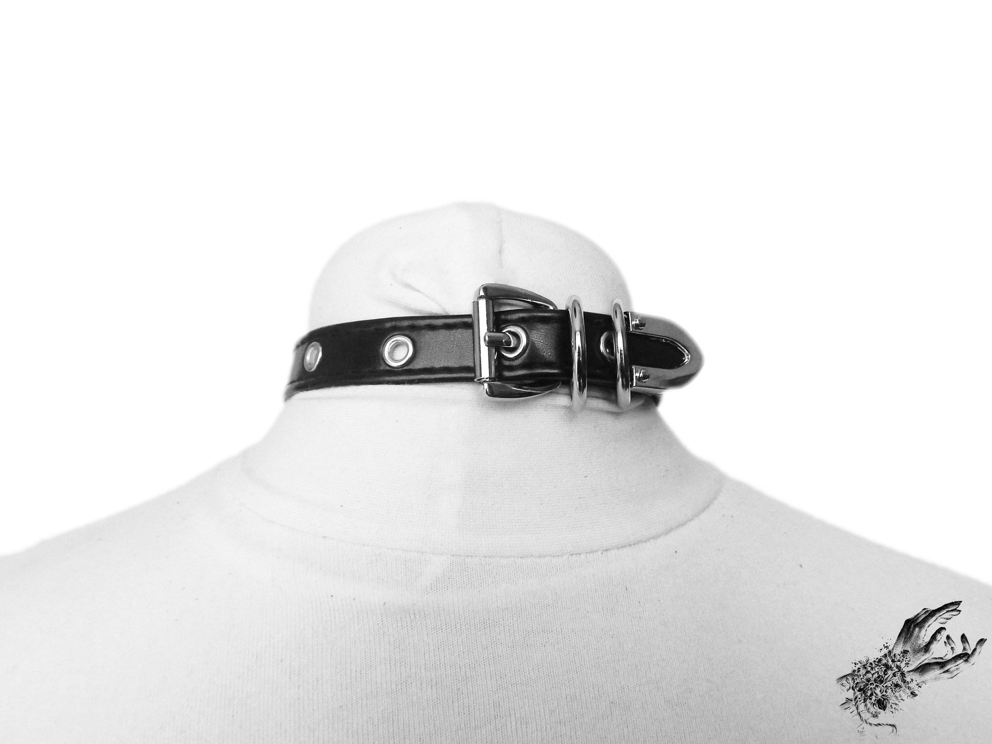 Rear view of the black faux leather cat charm choker, showing the stainless steel plated buckle and adjustable holes for versatile sizing, displayed on a white mannequin bust