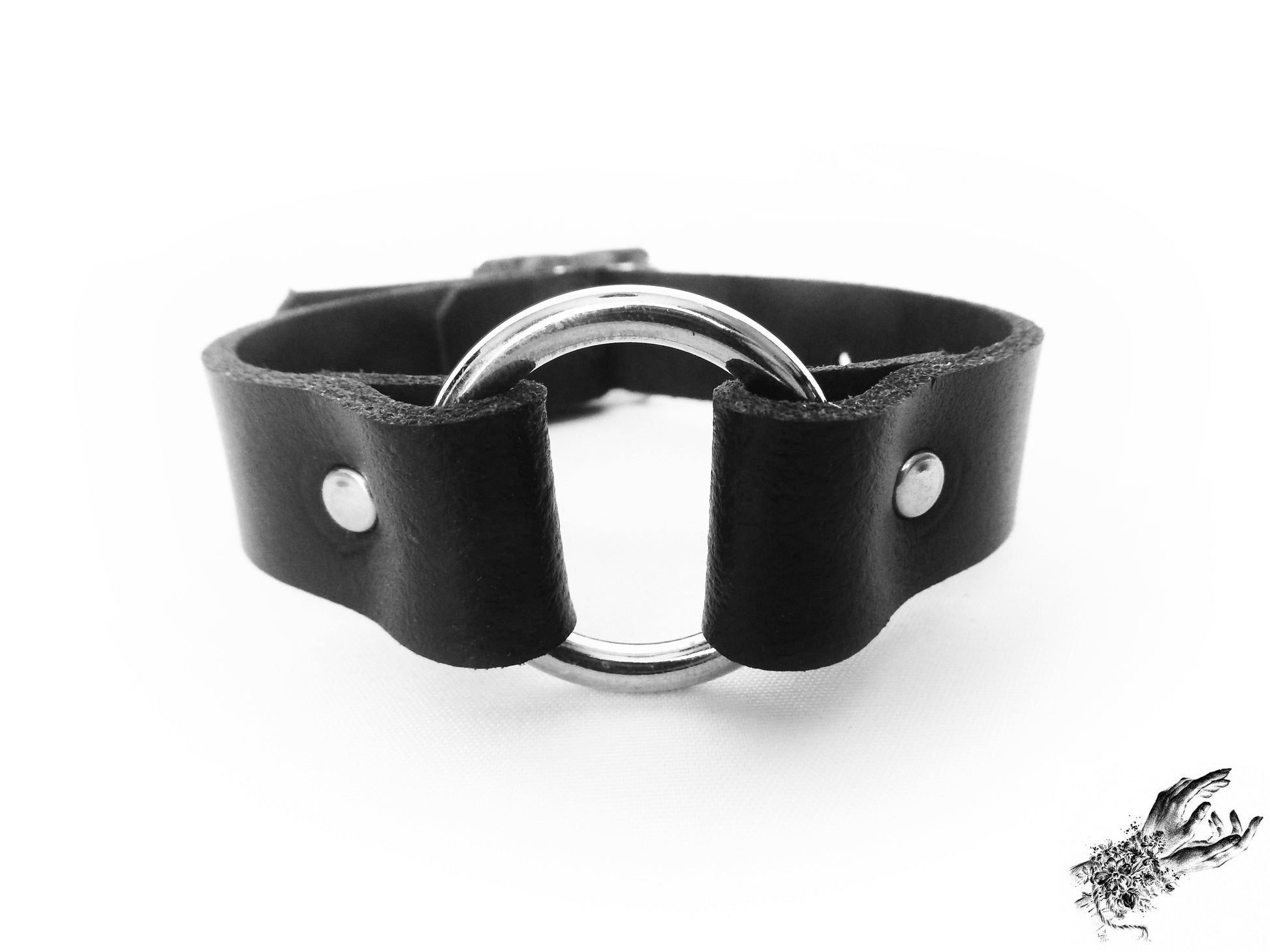 Close-up of the black leather o ring wristband, showing the central silver O ring and durable silver rivets for gothic and punk fashion in the UK