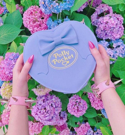 Modelled photo of pink spike studded wristband, styled with pink nails and a lilac Polly Pocket bag for a kawaii aesthetic