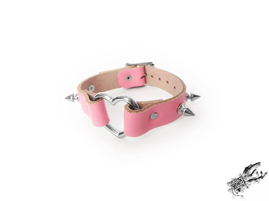 Pink studded heart ring wristband, made with genuine leather and stainless steel plated hardware in the UK for pastel goth and kawaii fashion