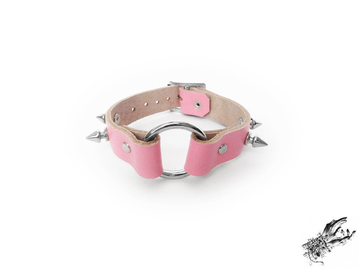 Pink leather wristband featuring a central silver O ring and bold 13mm spike studs, made in the UK for pastel goth and kawaii fashion