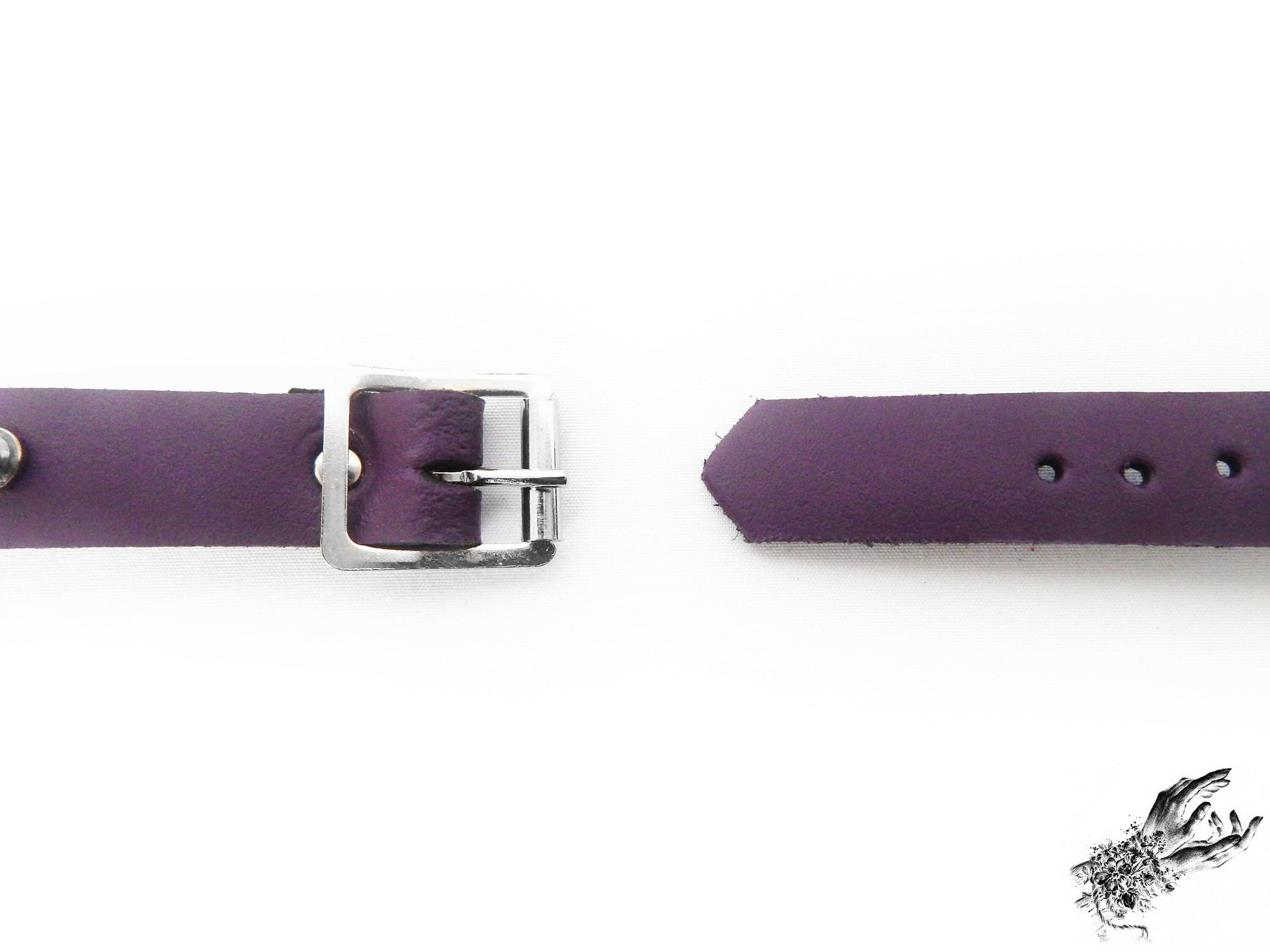 Close-up of the buckle on the purple leather heart ring wristband, showing the stainless steel plated buckle and holes for versatile sizing