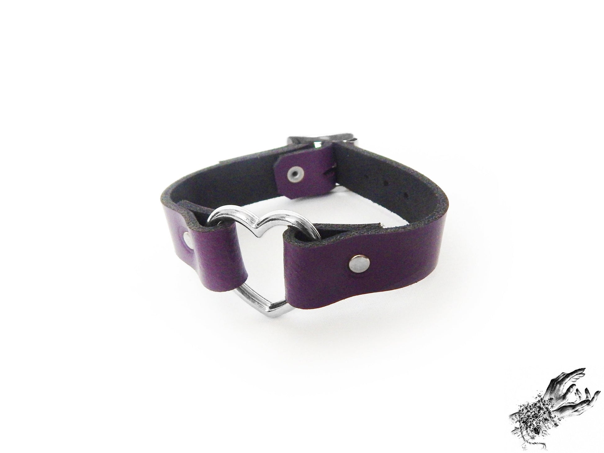 Purple leather wristband featuring a central silver heart ring and adjustable buckle