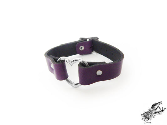 Purple leather wristband featuring a central silver heart ring and adjustable buckle