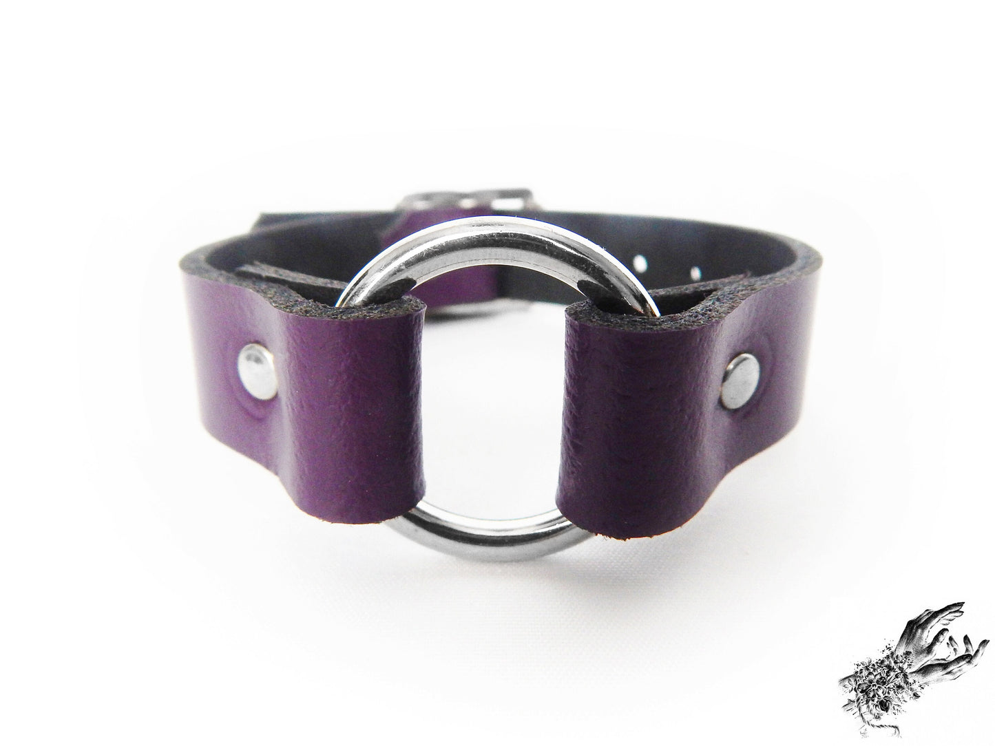 Close-up of the purple leather O ring wristband, showing the central silver O ring and durable silver rivets on a white background