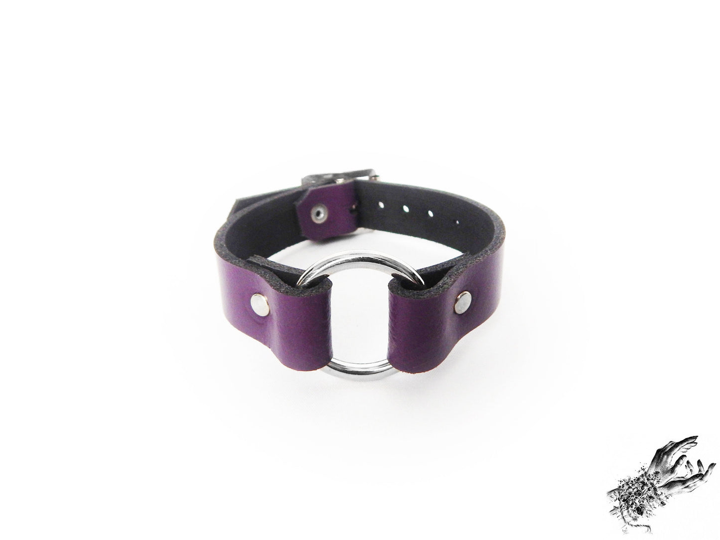 Purple leather wristband featuring a central silver O ring and adjustable buckle on a white background