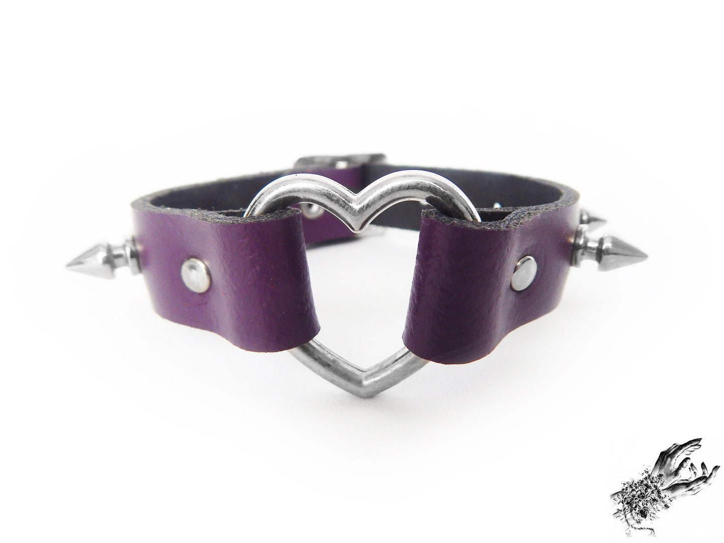 Close-up of the purple studded heart ring wristband, showing the central silver heart ring, bold 13mm spike studs and durable silver rivets