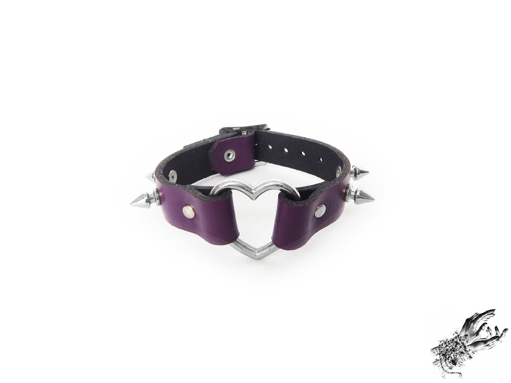 Purple leather wristband featuring a central silver heart ring and bold 13mm spike studs on a white background