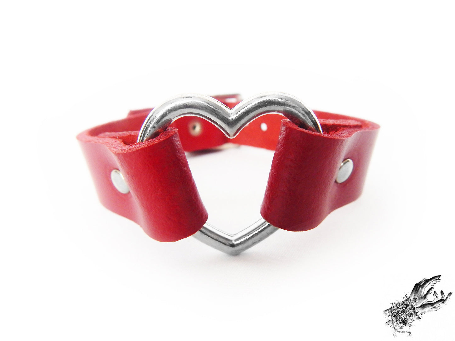 Close-up of the red leather heart ring wristband, showing the silver heart ring and durable silver rivets