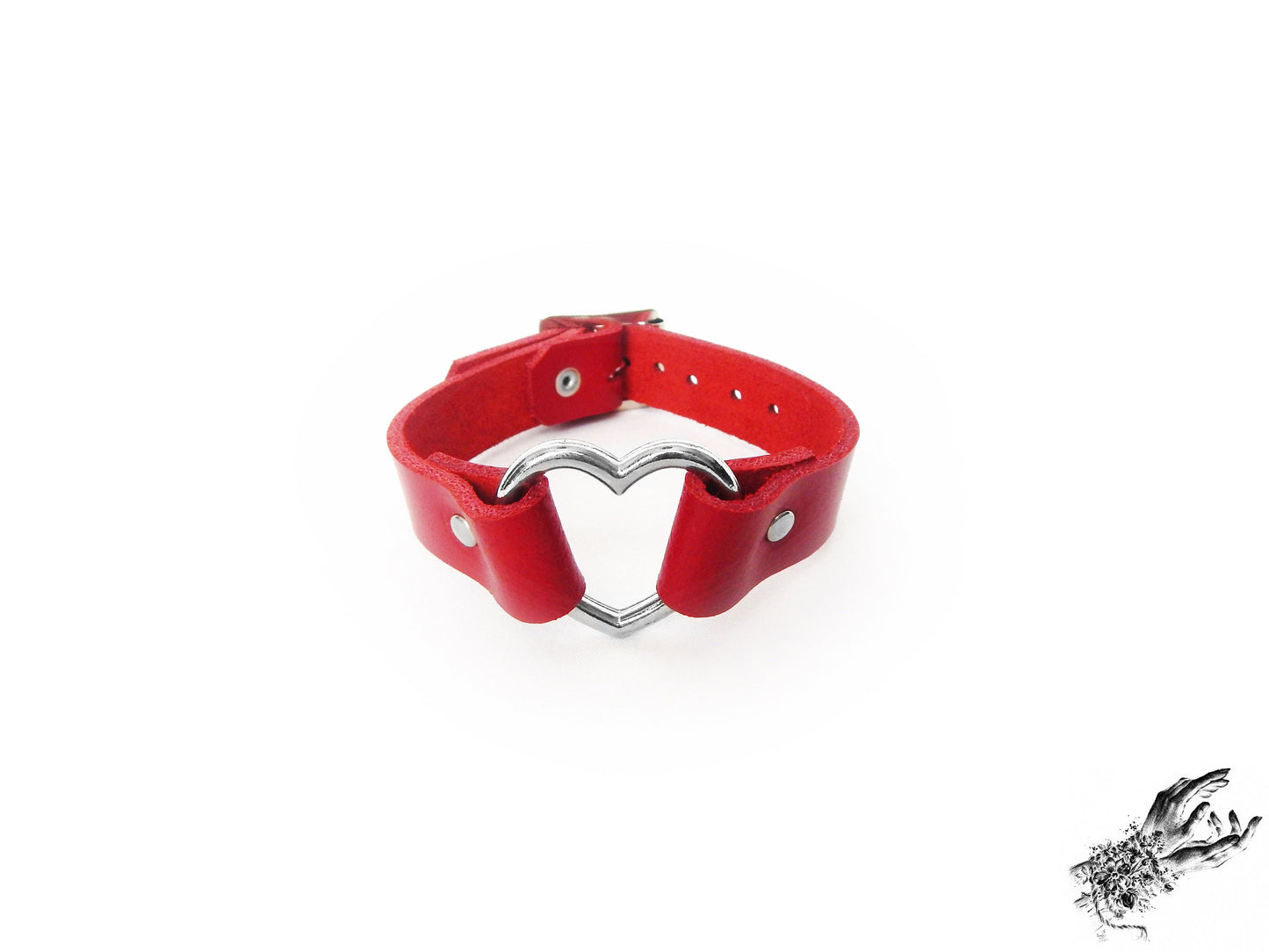 Red leather wristband featuring a central silver heart ring and adjustable buckle at the back