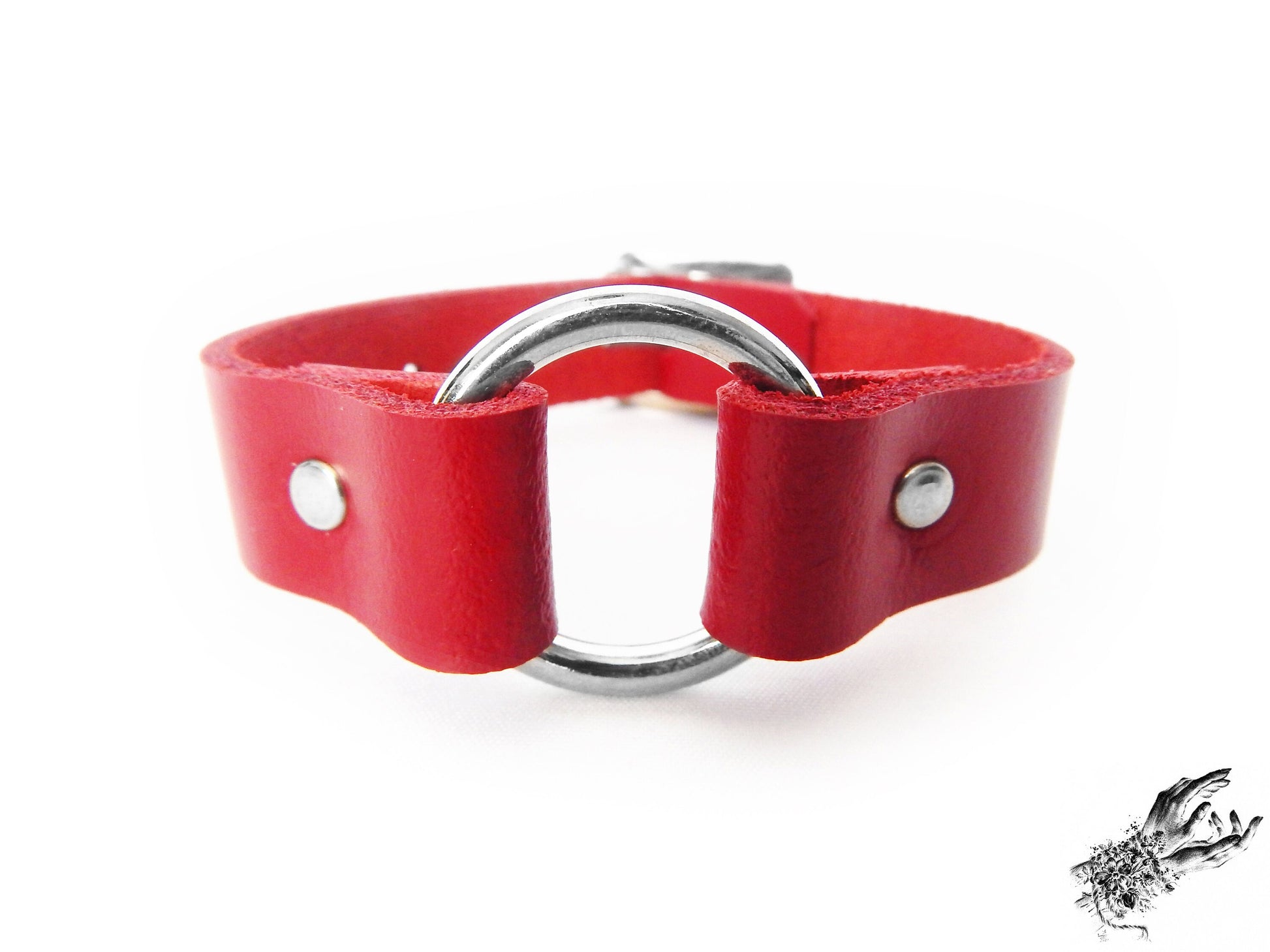 Close-up of the red leather O ring wristband, showing the stainless steel plated O ring and durable silver rivets on a white background