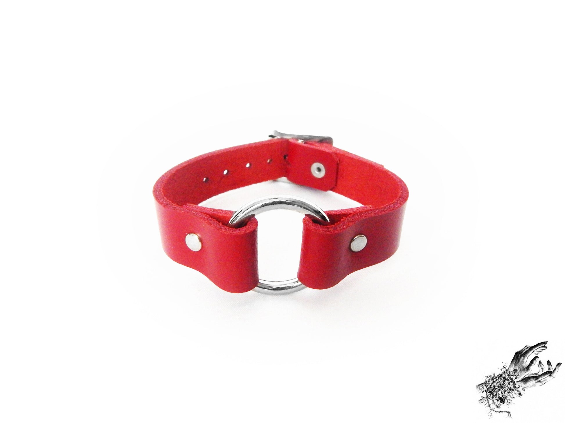 Red leather wristband featuring a central silver O ring and adjustable buckle on a white background