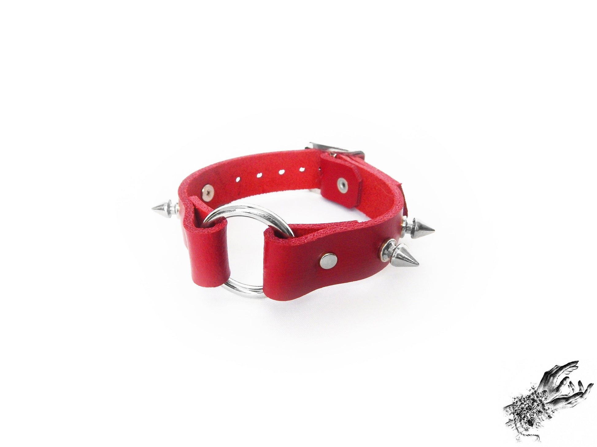 Red studded O ring wristband, made with genuine leather and stainless steel plated hardware in the UK for gothic and punk fashion