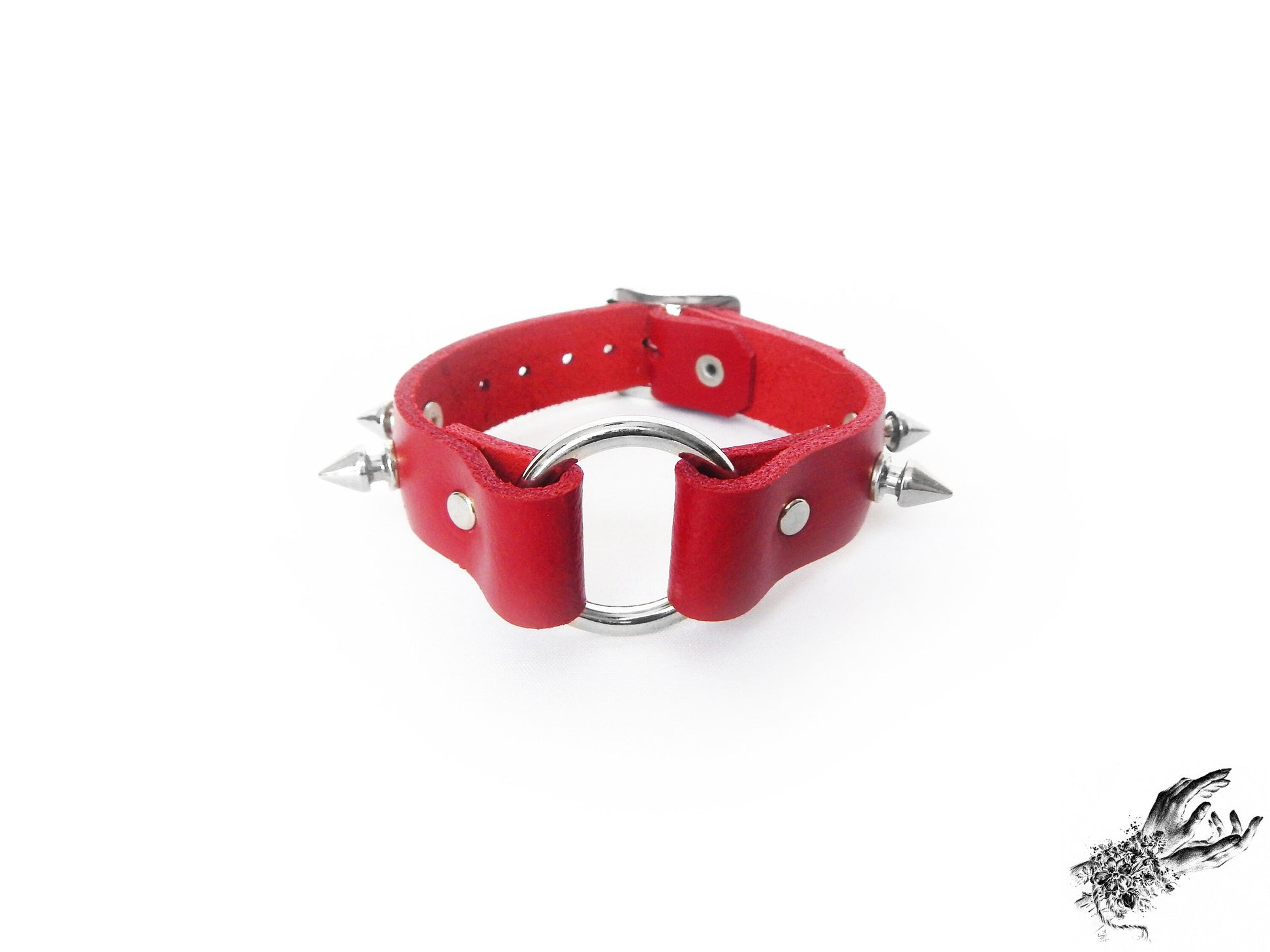Red leather wristband featuring a central silver O ring and bold 13mm spike studs for gothic and punk fashions