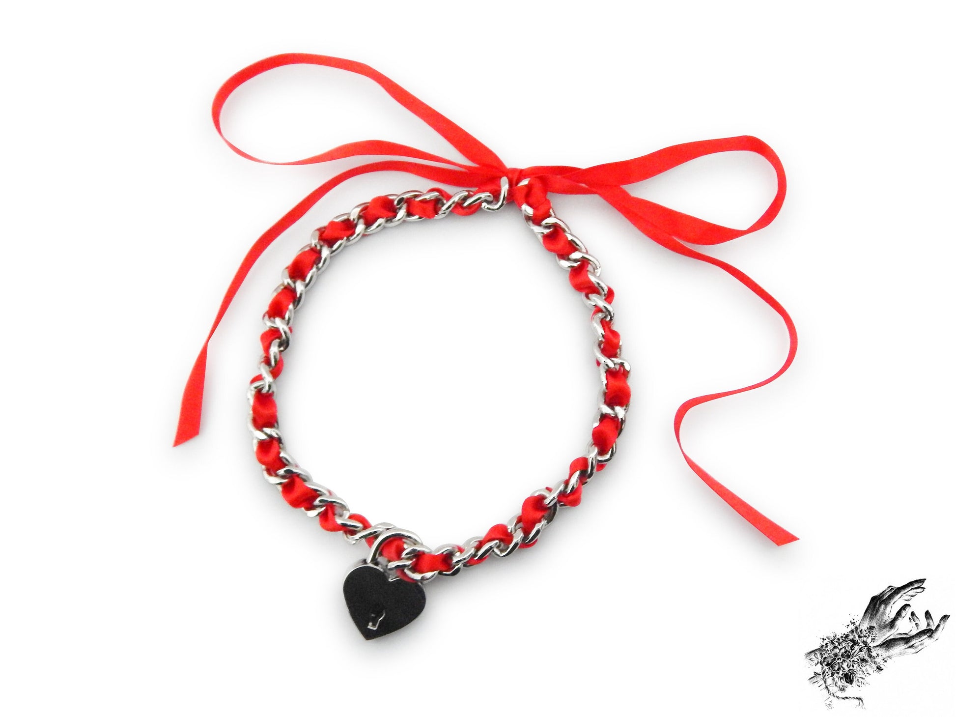 Silver chain choker threaded with red satin ribbon, featuring a removable central silver heart padlock with matching key, displayed on a white background.