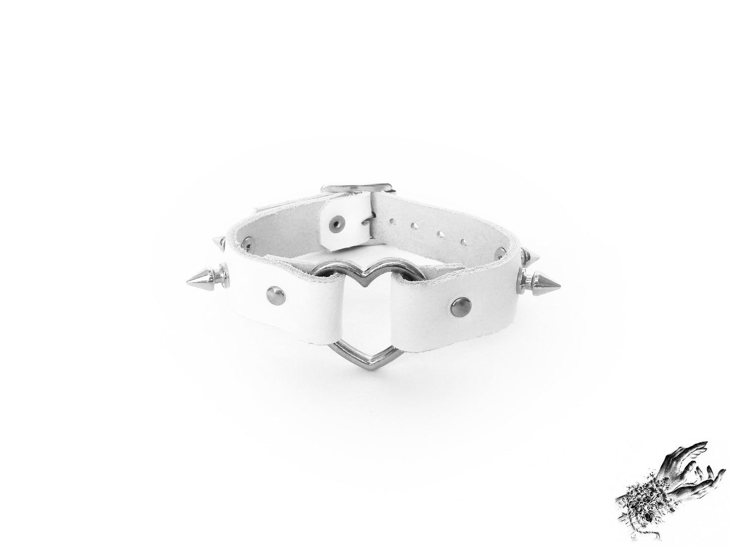 White leather wristband featuring a central silver heart ring and bold 13mm spike studs for pastel goth and alt fashion