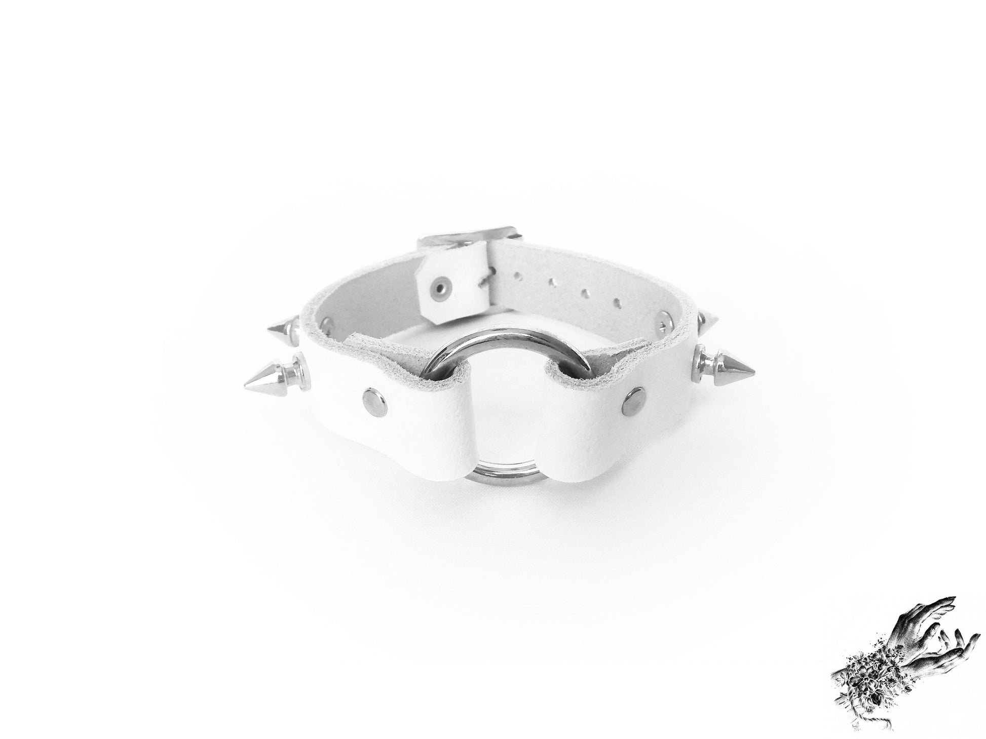 White leather wristband featuring a central silver O ring and bold 13mm spike studs, for pastel goth and kawaii fashion in the UK